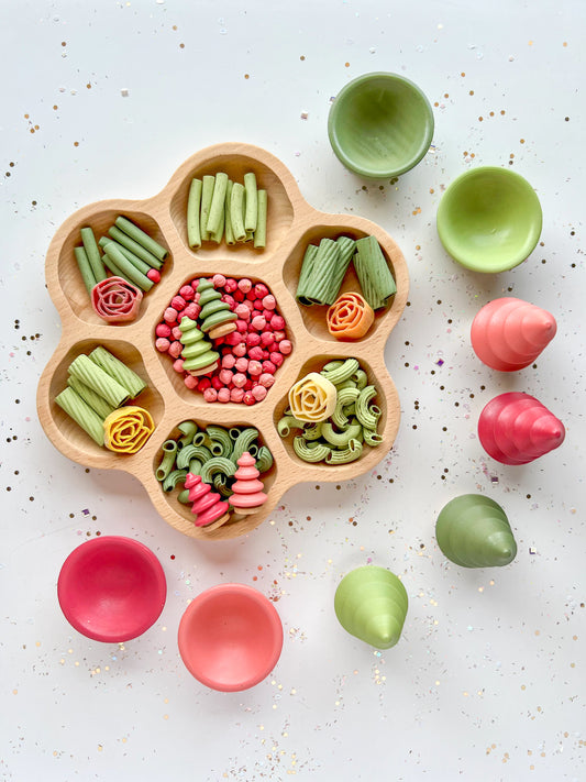 A clear plastic bag filled with colorful pasta and rice sensory bin filler with a label that reads 'Prickly Pear Sensory Bin Filler'.