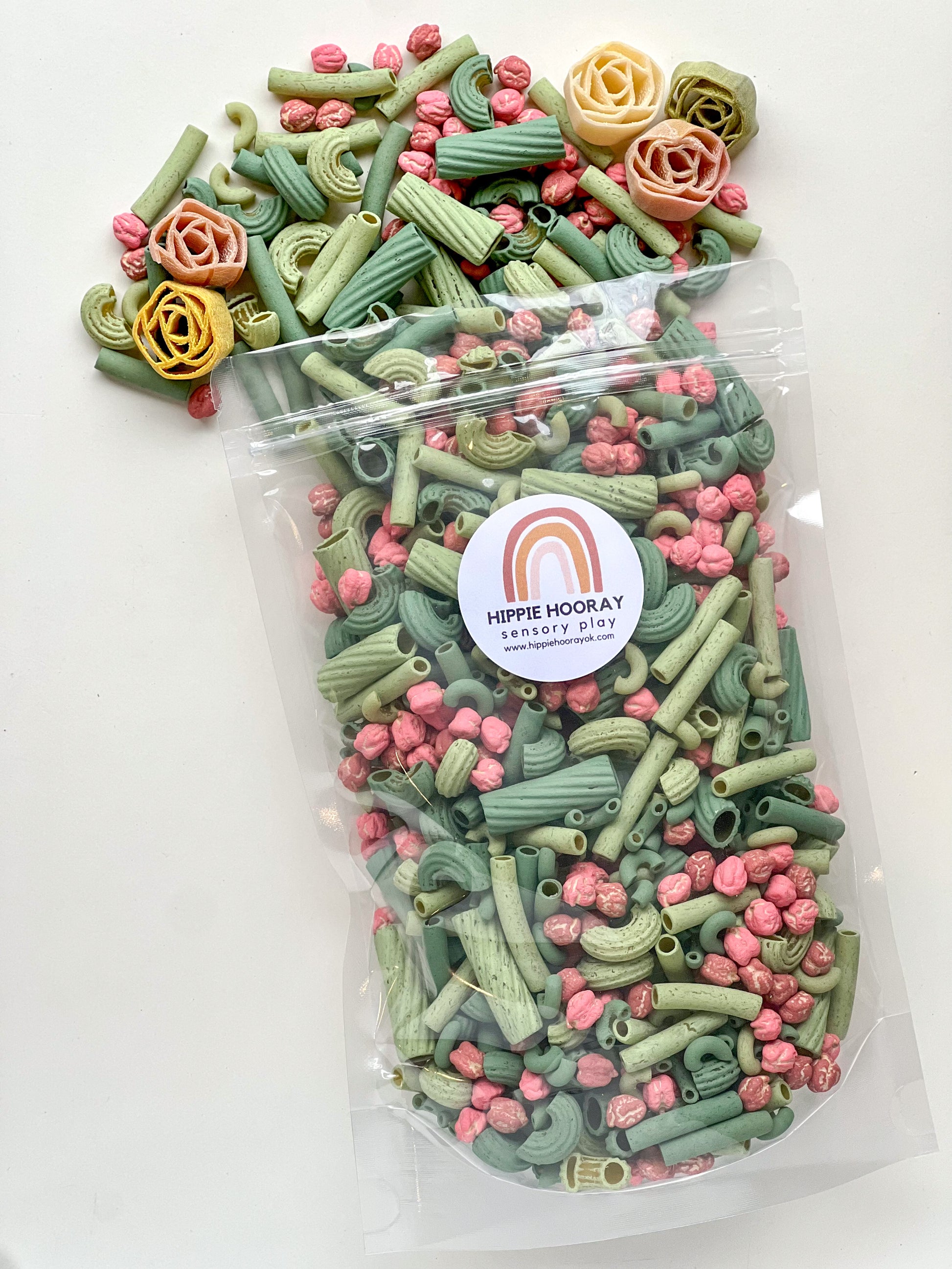 A clear plastic bag filled with colorful pasta and rice sensory bin filler with a label that reads 'Prickly Pear Sensory Bin Filler'.